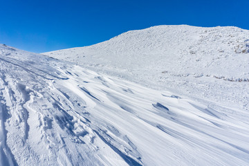 Winter landscape with wind sculpted patterns on snow- wind effect
