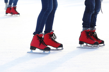 Female legs in skates on an ice rink