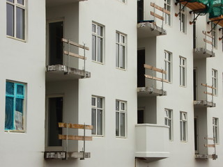 Construction Site White Building with unfinished Balcony
