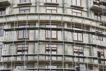 new building under construction, scaffolding and concrete