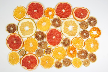 Fototapeta na wymiar mix of different pieces of dried citrus fruit on white background