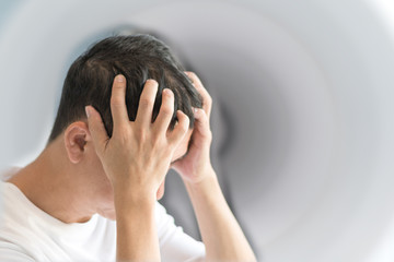 Vertigo illness concept. Man hands on his head felling headache dizzy sense of spinning dizziness,a...