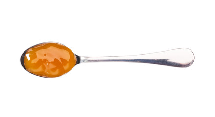 Orange sweet and sour sauce in small metal spoon  isolated on white background,top view