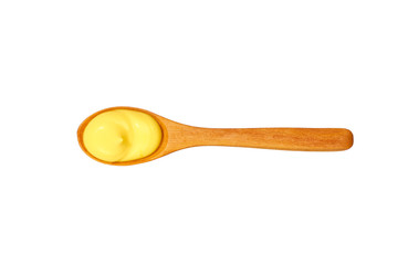 Cheese sauce in small wooden spoon isolated on white background,top view