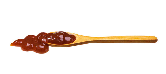 Barbecue sauce in small wooden spoon isolated on white background,