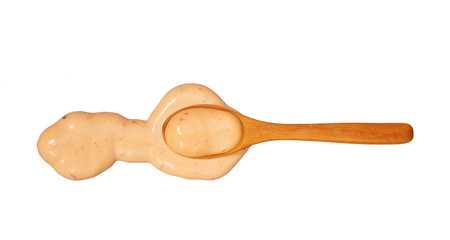 Paprika sauce   in small wooden spoon isolated on white background,top view