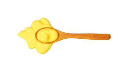 Cheese sauce in small wooden spoon isolated on white background,top view