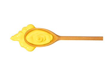 Cheese sauce in wooden spoon isolated on white background,top view