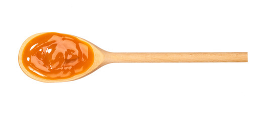 Orange sweet and sour sauce in  wooden spoon isolated on white background,top view