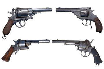 Four antique revolvers isolated on white background.