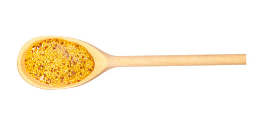 Mustard sauce in  wooden spoon isolated on white background,top view