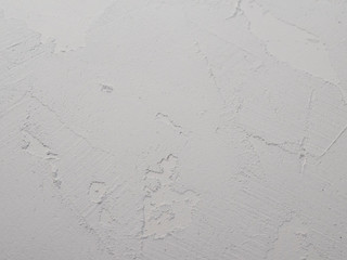 White abstract background or texture of concrete wall with rough stucco. Textured damaged plaster, loft style.