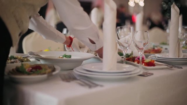 Waiters served festive table in the restaurant.