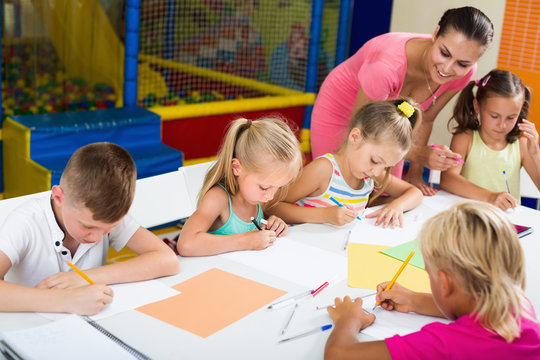 Positive children drawing on lesson in  class