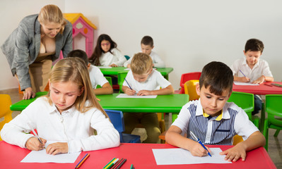 School kids studying in classroom with teacher