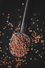 Directly above shot of Sichuan peppercorns on black background