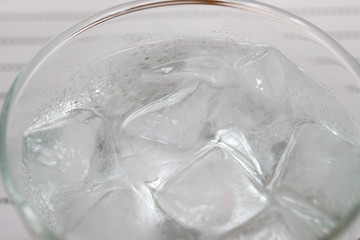 Ice cubes floating on clear water to make the water cool and make refreshment for drinking 
