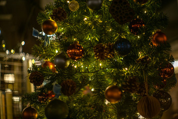 Fototapeta na wymiar Colorful glass baubles and other decorations on a Christmas tree in London - 3