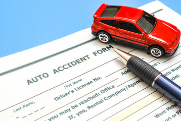 Car accident form, pen and toy car on blue background. Selective focus