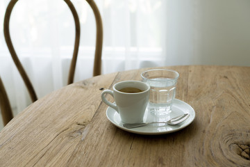 cup of coffee on wooden table, espresso and pure water
