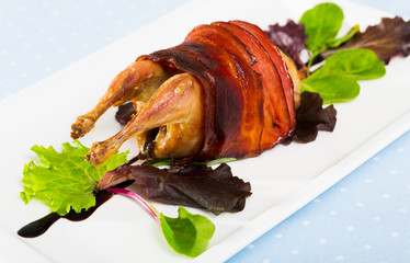Photography of plate with baked in bacon quail with balsamic sauce