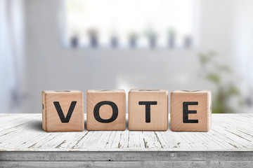 Vote sign made of wood in a bright room