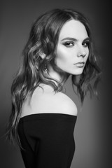 Fototapeta premium Fashion portrait of young lady in black dress