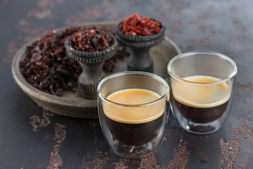 Espresso coffee in small glass cups on the background of ceramic cups for Smoking hookah filled with different types of Shisha