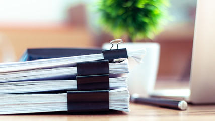 Stack of documents placed on a business desk in a business office. - obrazy, fototapety, plakaty