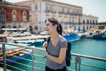 Female tourist backpacker visiting Italy.Woman in Syracuse,Sicily.Old town of Syracuse, Ortigia...