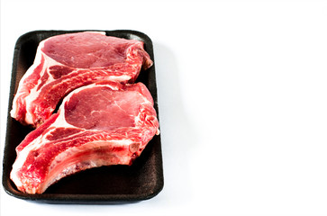 Top view of black foam food tray with Raw marbled meat steak isolated on white