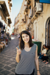 Female tourist backpacker visiting Italy.Woman in Syracuse,Sicily.Old town of Syracuse, Ortigia island visitor.Travel destination in south Italy.Italian experience.Travel photography.European trip