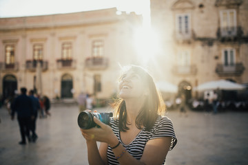 Female tourist backpacker visiting Italy.Woman in Syracuse,Sicily.Old town of Syracuse,...