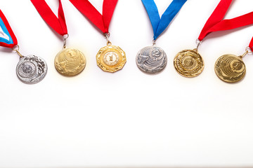 Gold and silver medals with ribbon on white background.