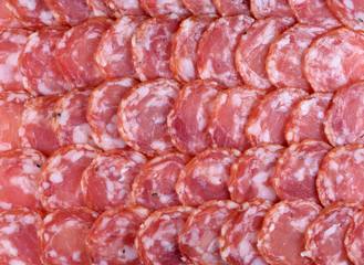 Salami sausage slices background. Close up. Slices of smoked sausage. Food background.