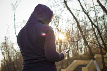  Girl in sportswear jogging with the phone