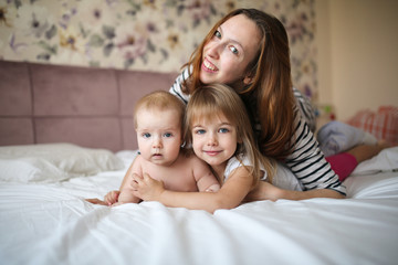 mother with two children in a gentle real room