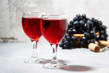 two glasses of red wine on a gray background, closeup