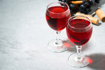 two glasses of red wine on a gray background, top view
