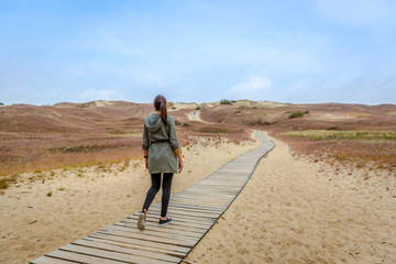 Young woman having fun in Curonian Spit National Park in Lithuania