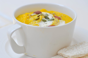 pumpkin soup with almond , watermelon seed topping