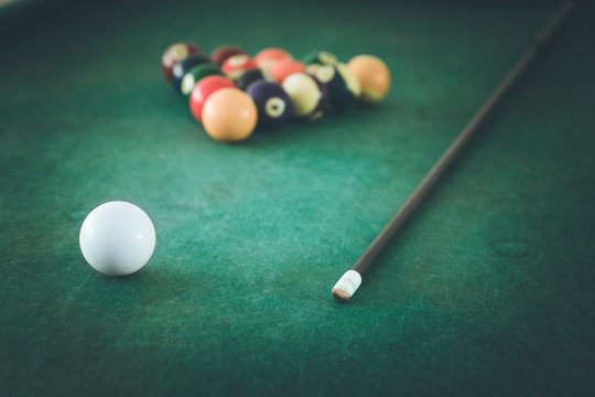 Billiard in a bar, queue and balls on the table, quitting time