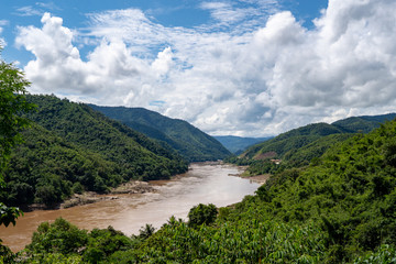  The Mekong River that flows among the mountains on a cloudy day