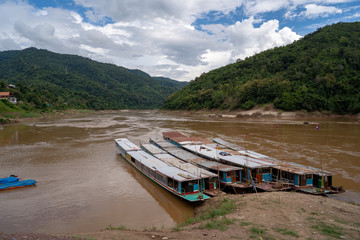 The slow boat parked on the banks of the Mekong River.