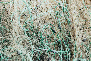 Tangled fishing nets fill the screen in close-up. Fisherman's tackle from kapron