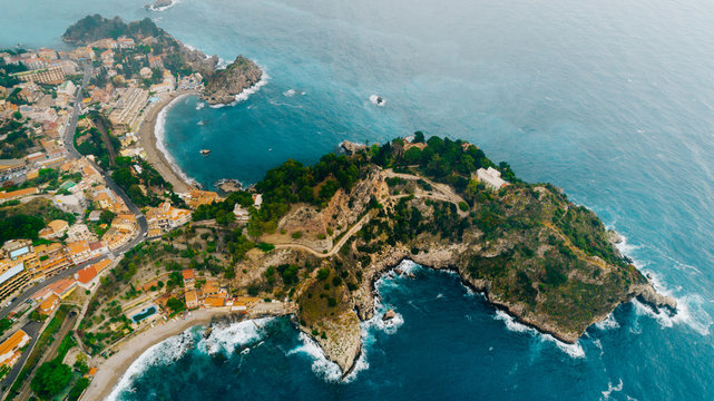 Aerial view of charming coastal Mediterranean small town on Sicily island, Taormina. Beaches of Taormina and south Italy.Travel destination, vacation in Italy concept.Aerial landscape of Bella Isola © eldarnurkovic
