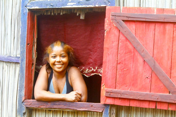 Happy malagasy woman in her traditional house