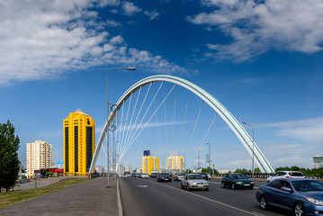 Fototapeta na wymiar Arch of the bridge across the Ishim river in Astana