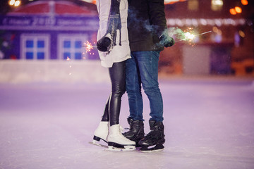 Loving couple skating on winter rink. Concept of care and date Valentine Day