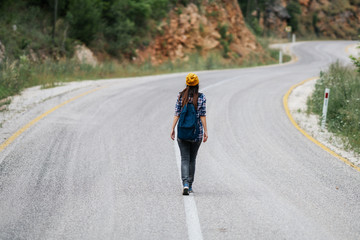 traveler woman on the road, summer holiday travelling or young tourist concept